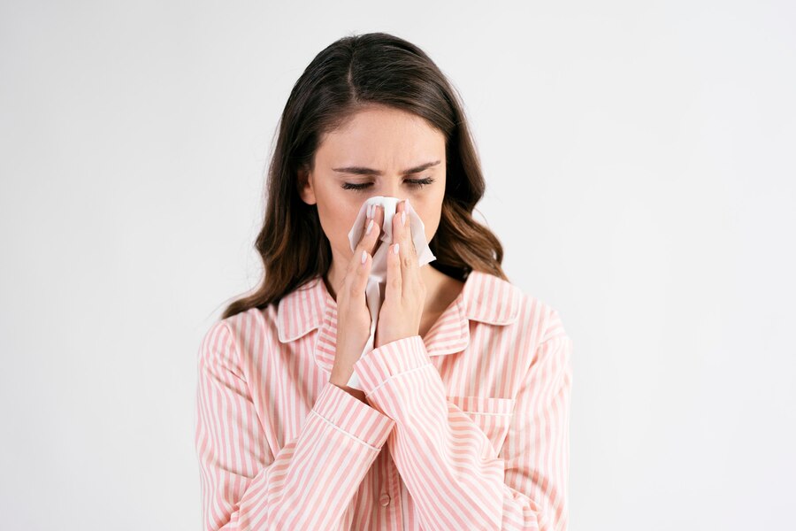 sick-young-woman-blowing-nose